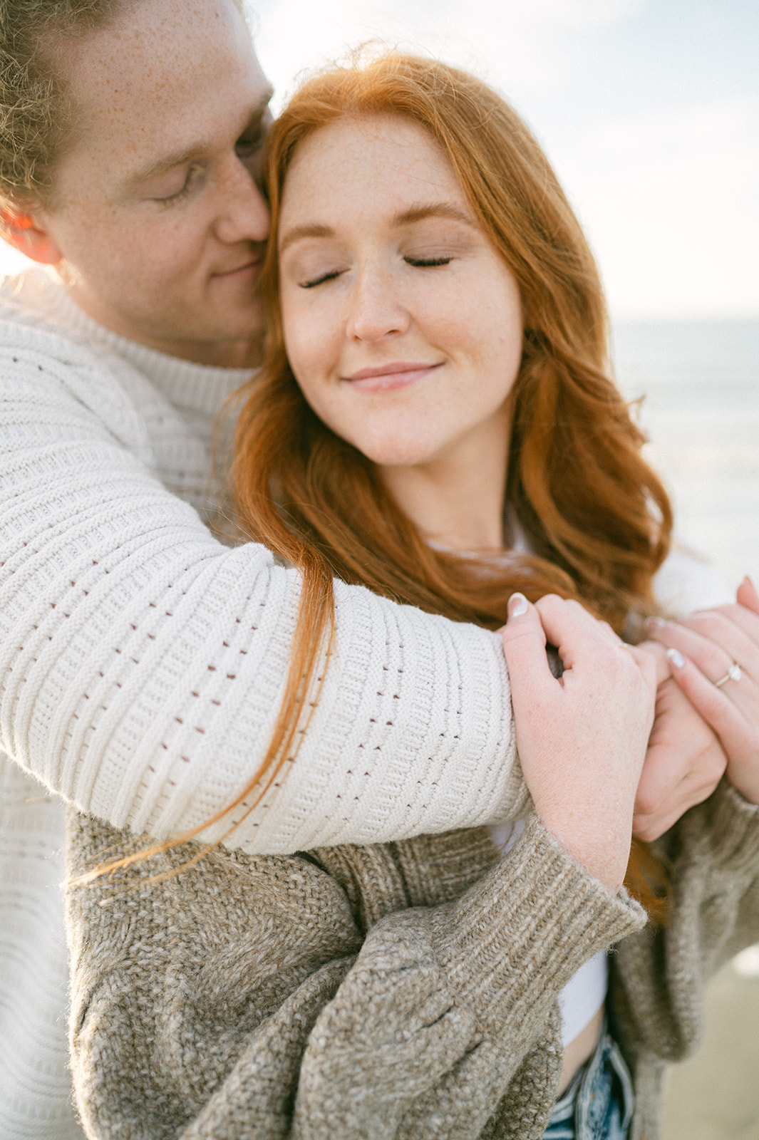 Hug from behind engagement photo pose for couples. 