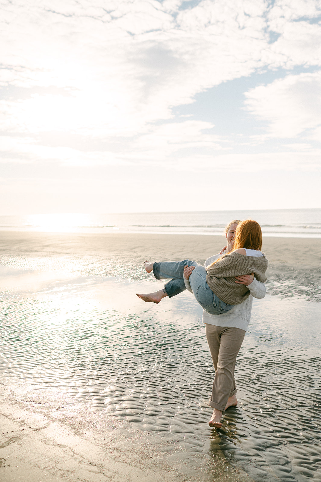 Playful beach engagement photo at Sullivan's Island Beach, South Carolina.