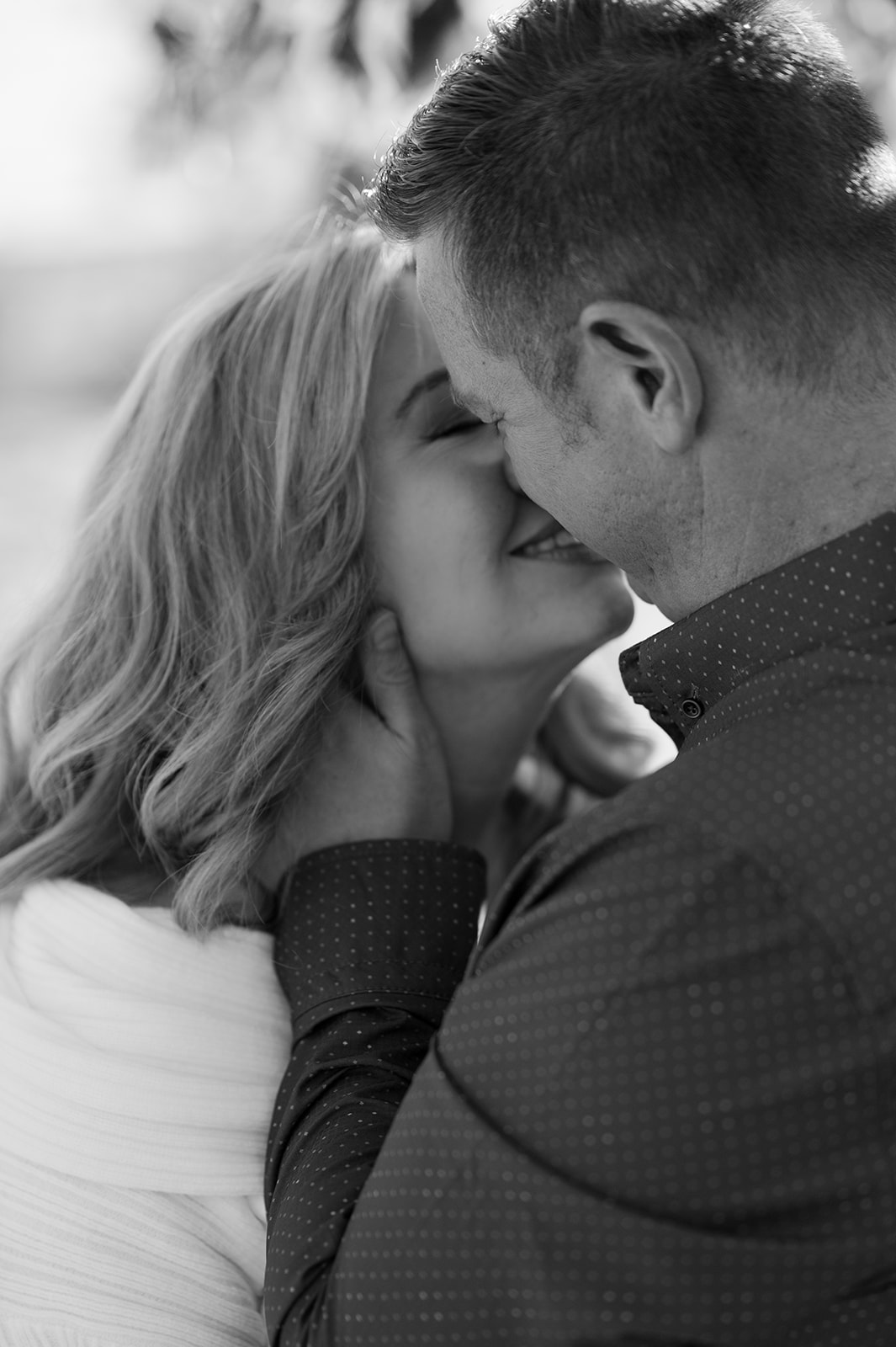 Couple leaning in for a kiss engagement photo. 