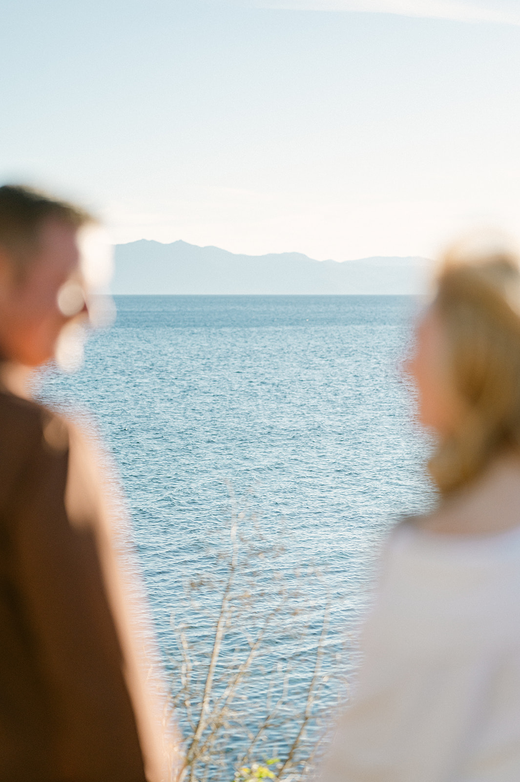 Out of focus couple holding hands at Lake Tahoe. 