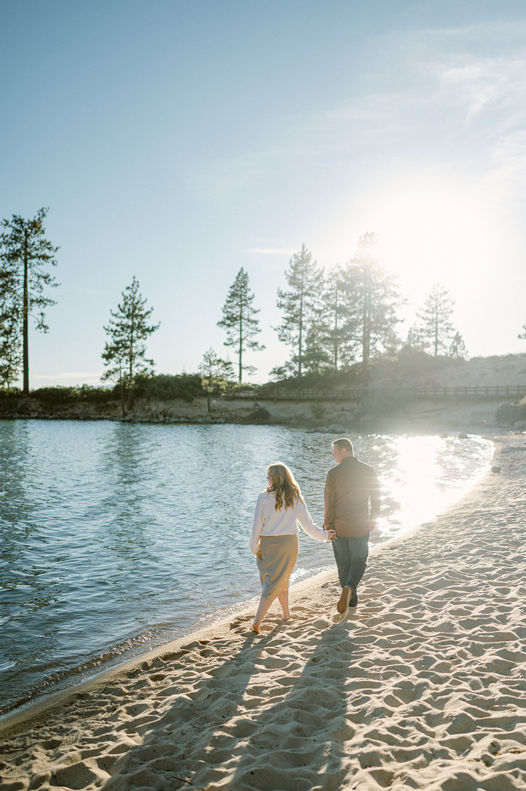 Candid couple walking on the beach at Sand Harbor for their Lake Tahoe engagement session. 