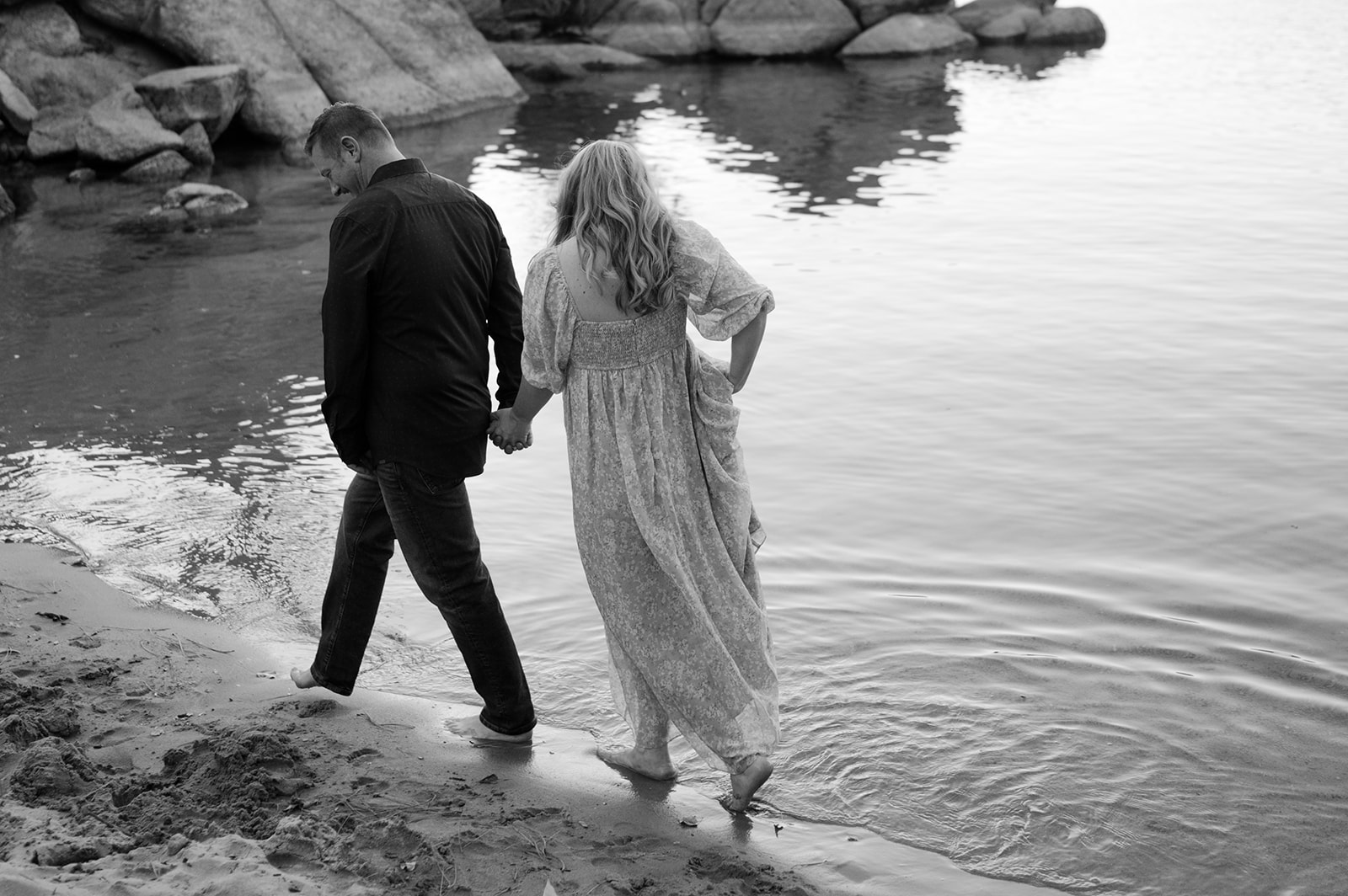 Couple walking on the beach at Sand Harbor. 