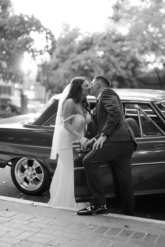 Vintage getaway car wedding photo captured by fine art photographer Sarah Woods. 