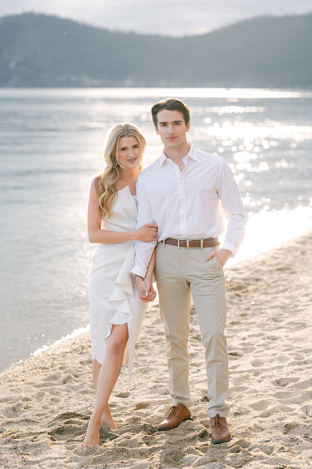 White formal dress and khaki pants formal engagement photo outfit idea for spring.