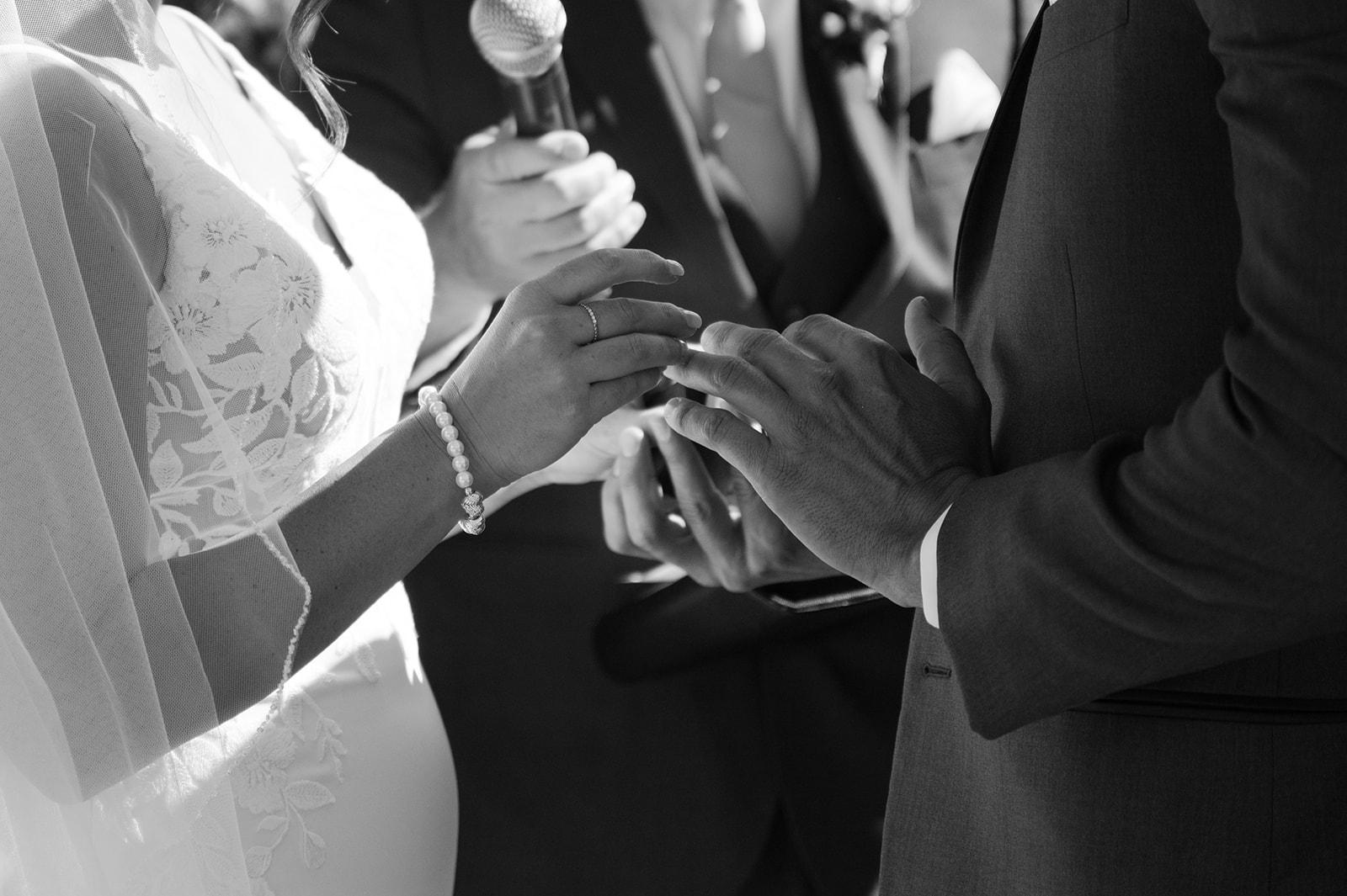 Bride and groom exchanging rings–documentary style photography.