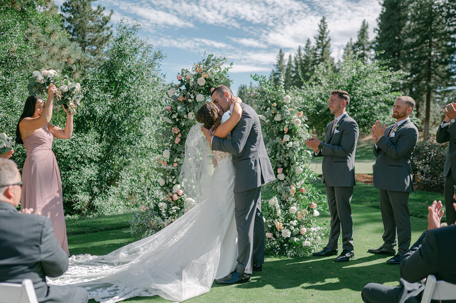 Bride and groom first kiss at a romantic outdoor wedding ceremony in Lake Tahoe.