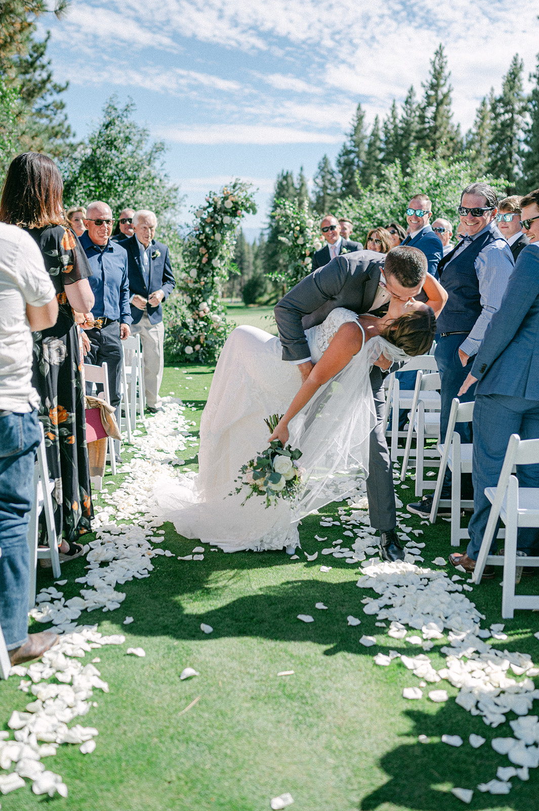 Bride and groom ceremony dip kiss walking down the aisle at a Lake Tahoe wedding. 