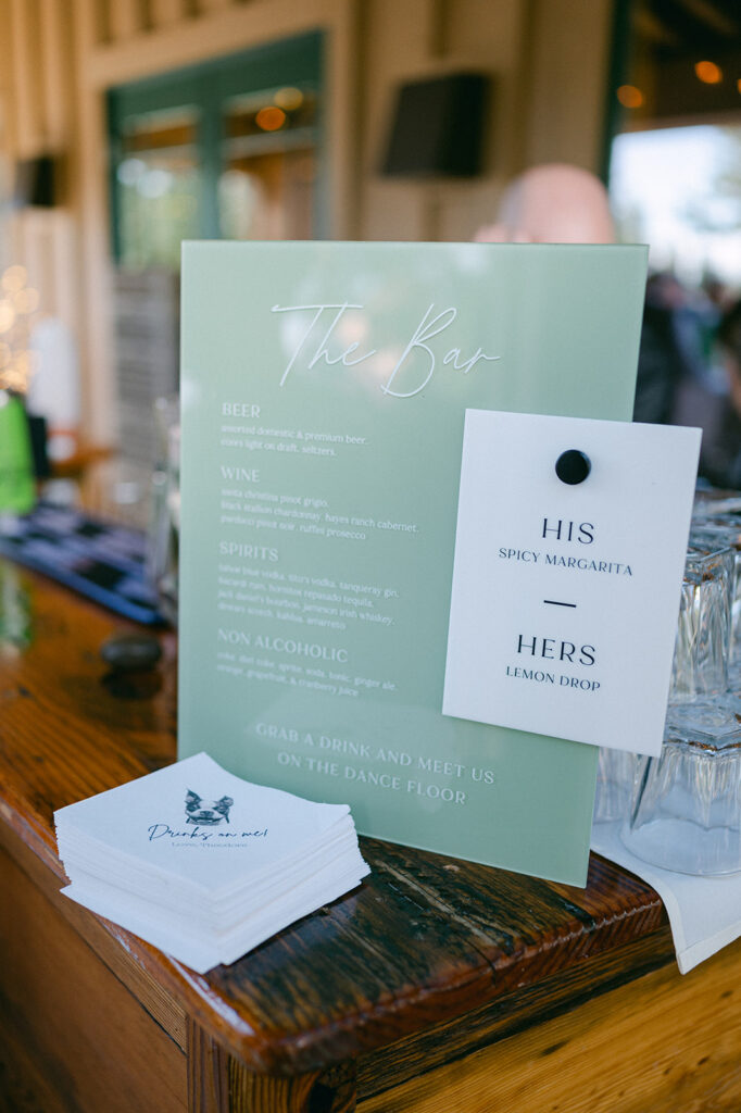 Bar menu with his and her cocktails and custom dog wedding napkins. 