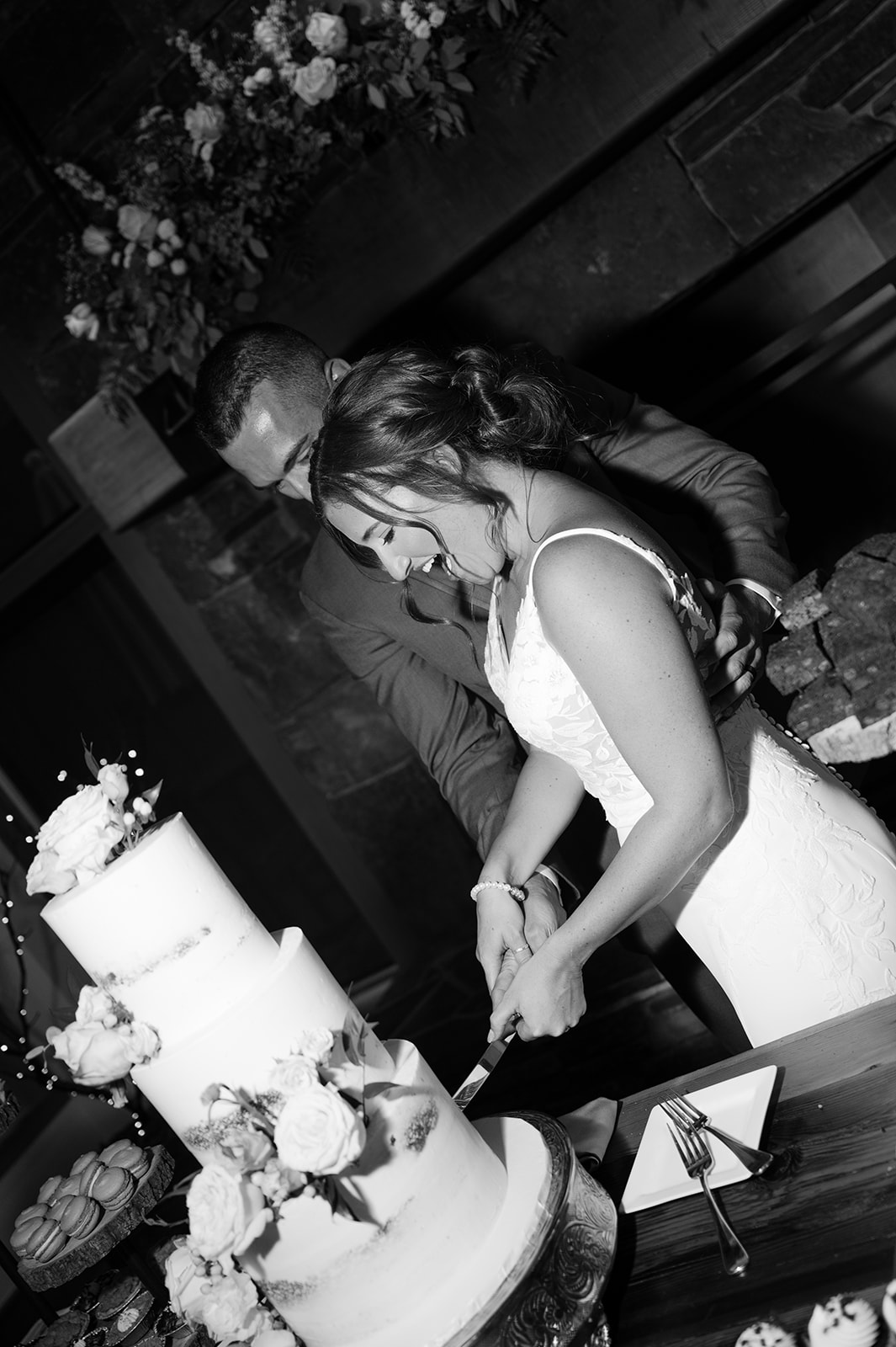 Bride and groom cake cutting documentary style photo. 