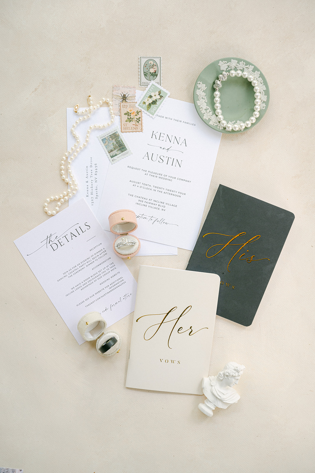 Romantic wedding detail flat lay with stationery, vow books, rings and pearls. 