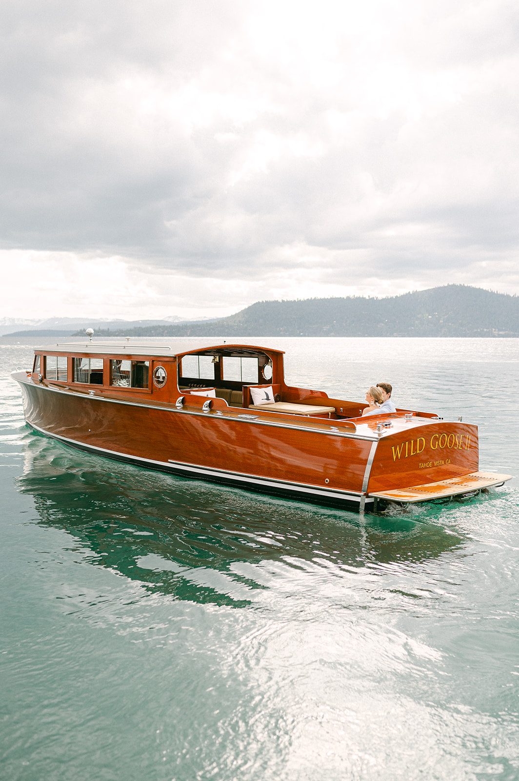 Timeless Lake Tahoe wedding featuring the Wild Goose 2 wooden boat.