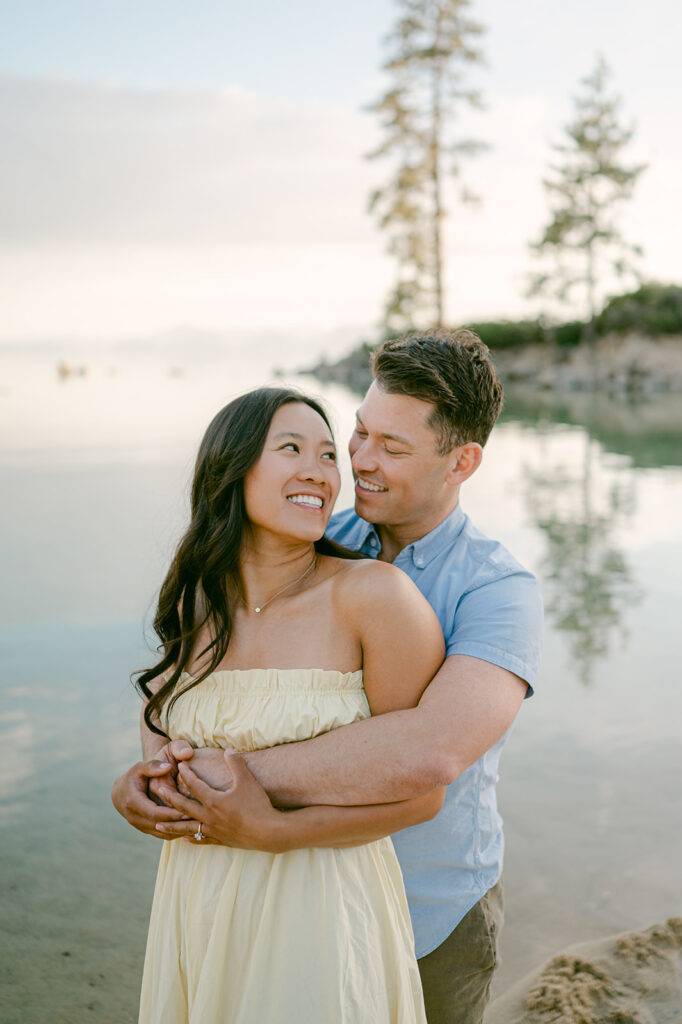 Couple embracing with Lake Tahoe in the background.