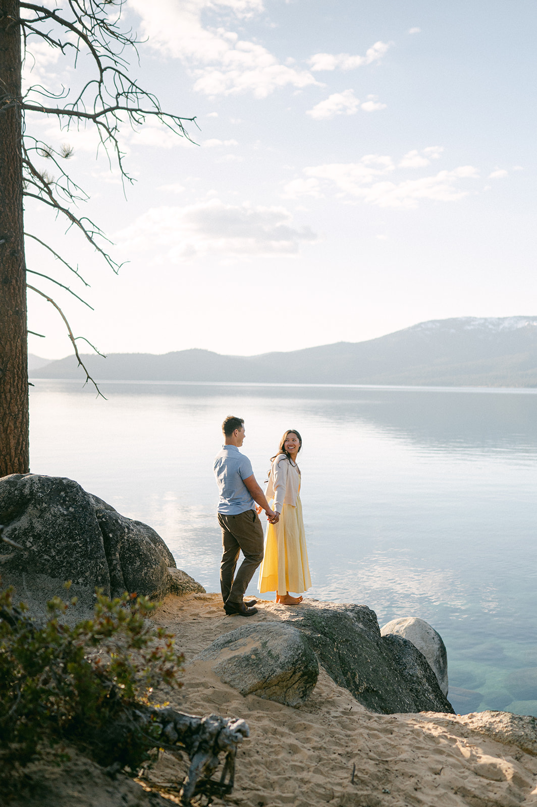 Couple holding hands on the shores of Sand Harbor, Lake Tahoe.