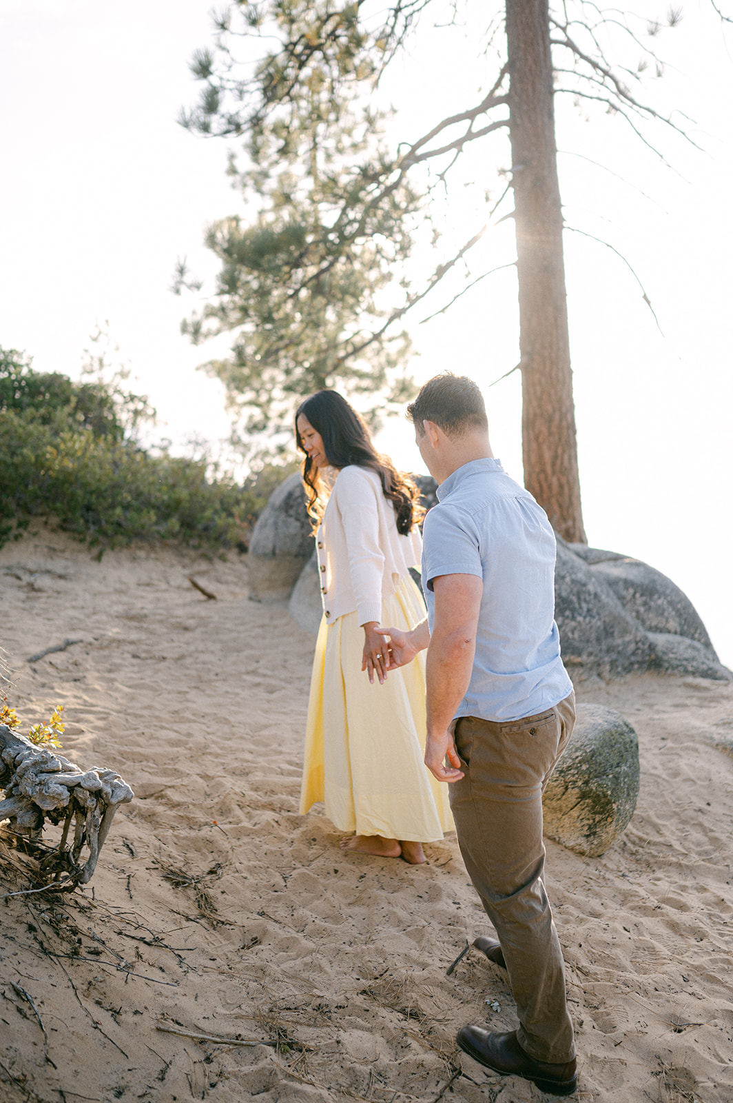 Couple walking hand-in-hand towards the boulders at Sand Harbor.