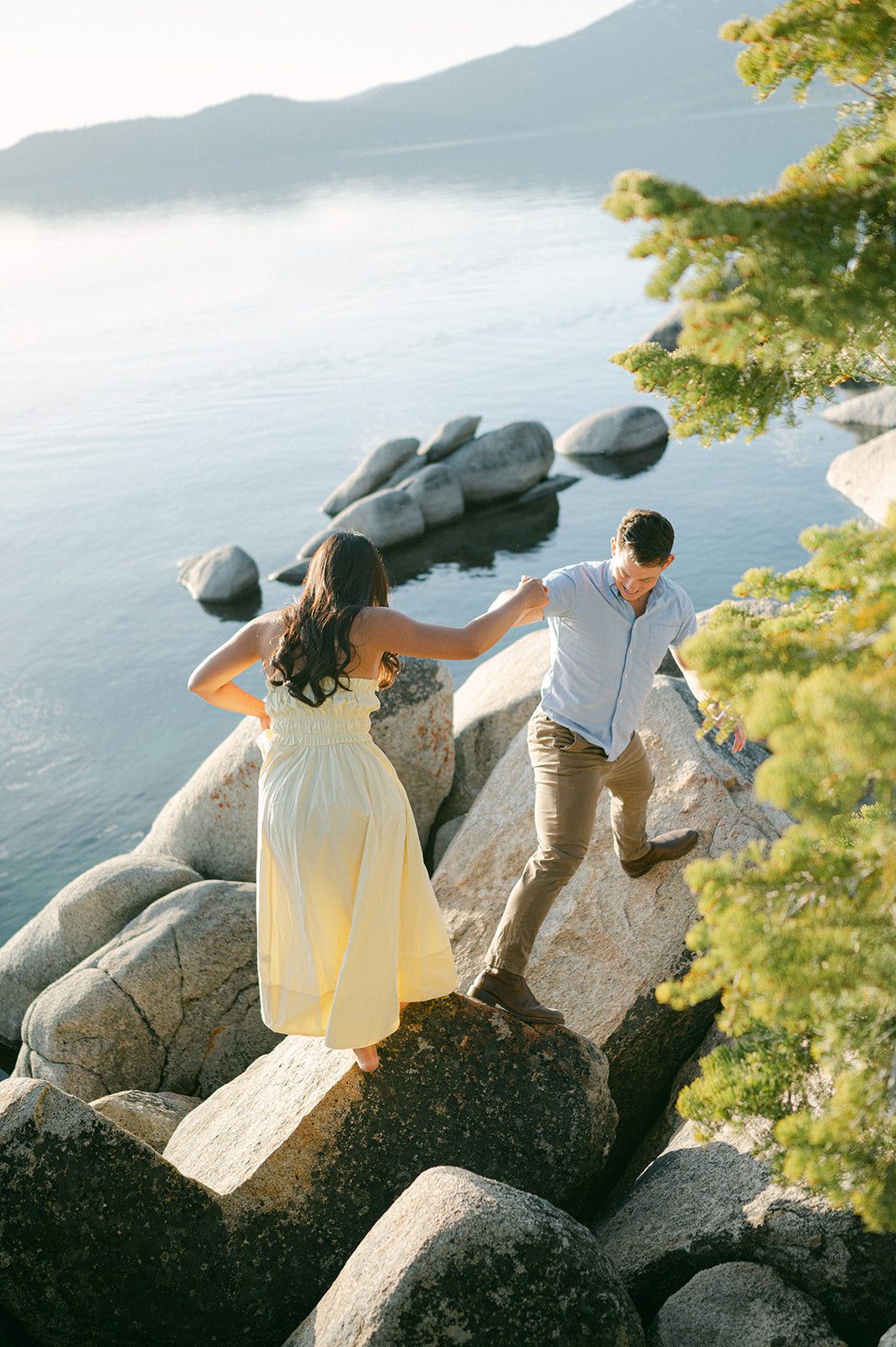 Couple walking up the boulders at Sand Harbor.