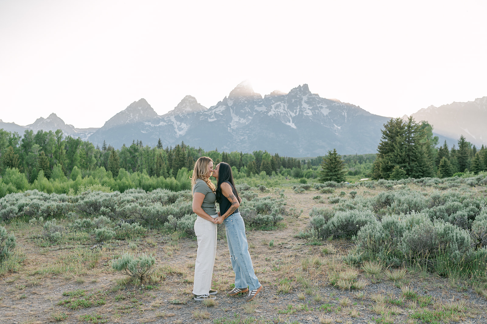 WLW couple’s session in Jackson Hole wearing casual outfits and mountain views in the background