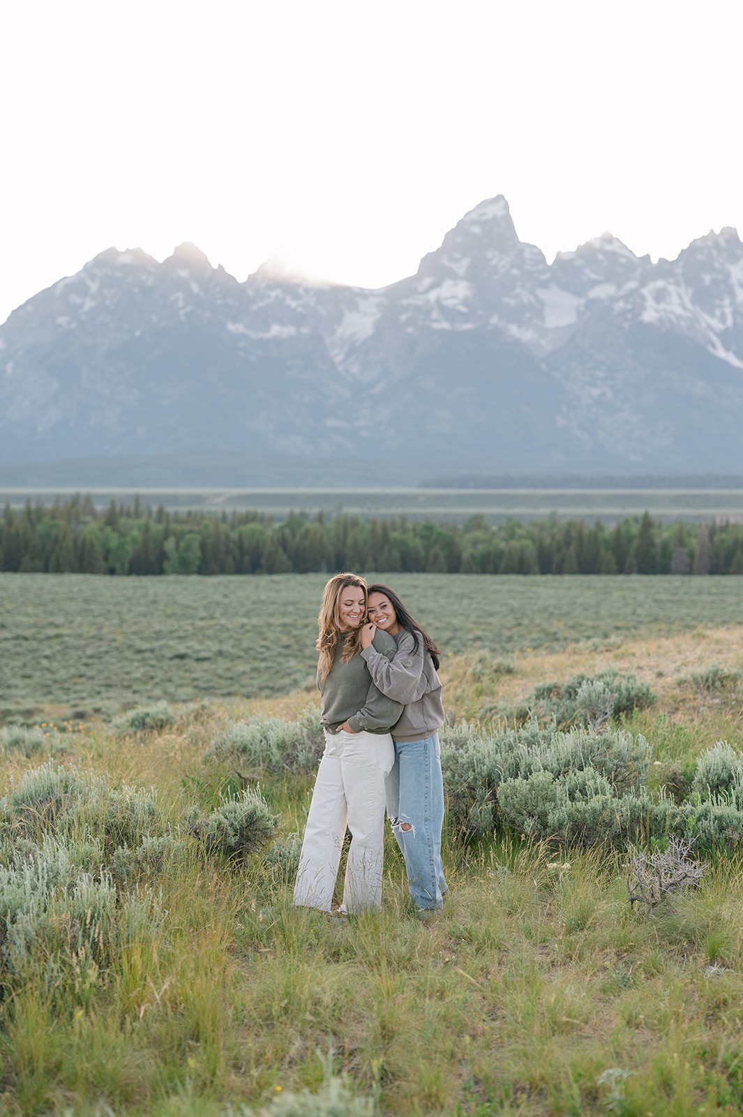 Candid mountain couple’s session featuring wlw couple in relaxed outfits in Jackson Hole.