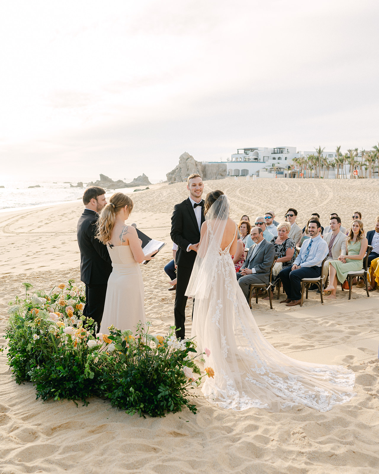 Wedding ceremony photo behind the altar with guests in view.