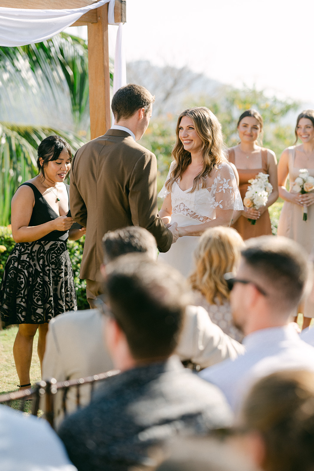 Bride and groom holding hands during vows | timeless, intimate ceremony photo.