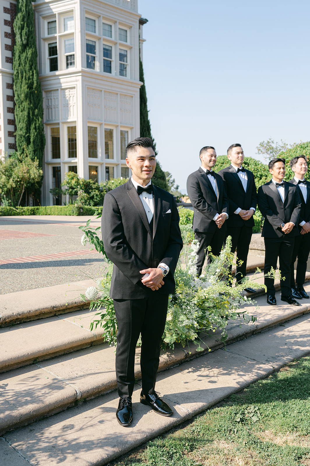 Groom watching bride walk down the aisle.