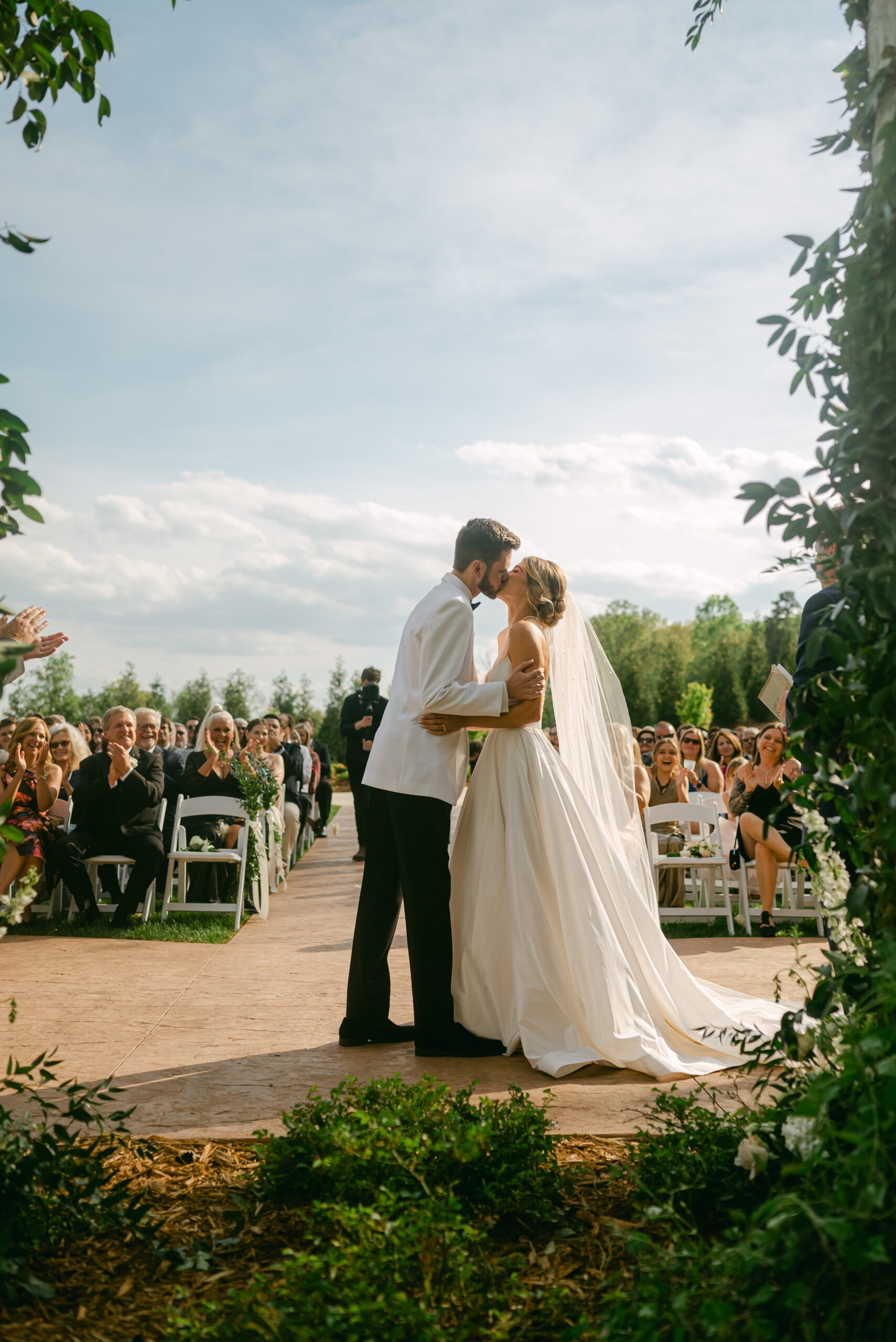 First kiss from behind the altar with guests in view | must-have wedding ceremony photo.