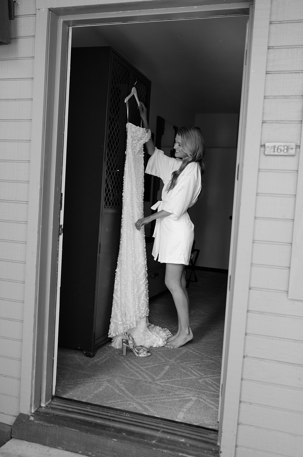 Bride looking at her wedding dress while getting ready | timeless documentary wedding photo.