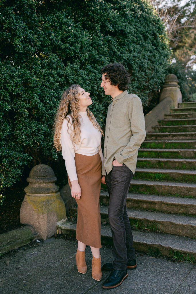 Neutral fall engagement photo outfits with a suede skirt. 