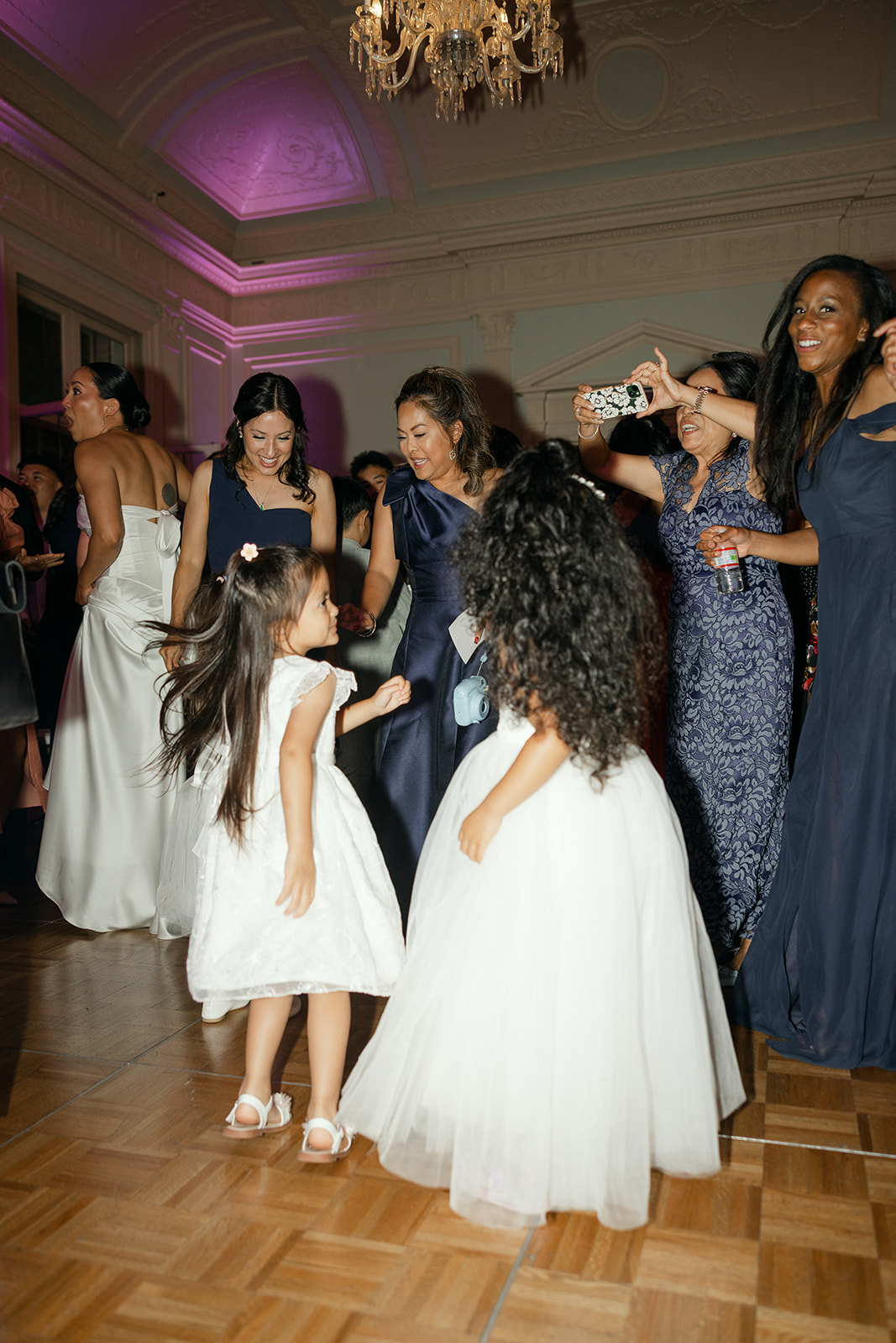 Wedding party celebrating on the dance floor inside Kohl Mansion.