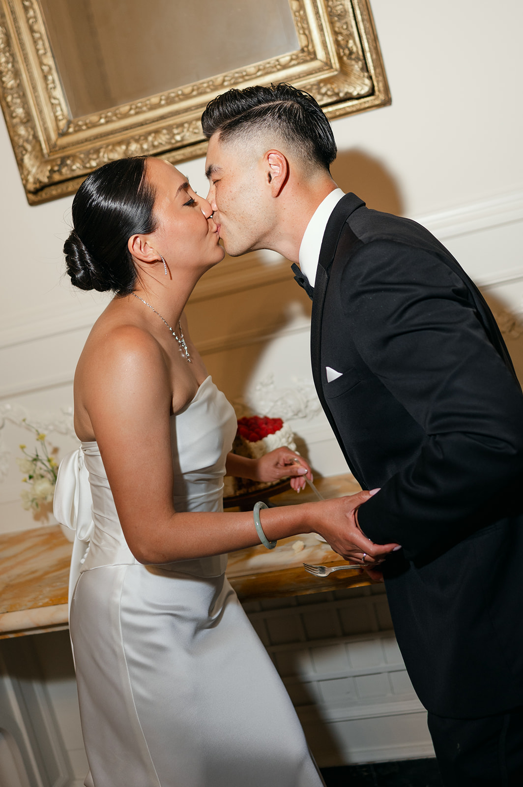 Bride and groom cake cutting kiss at Kohl Mansion.