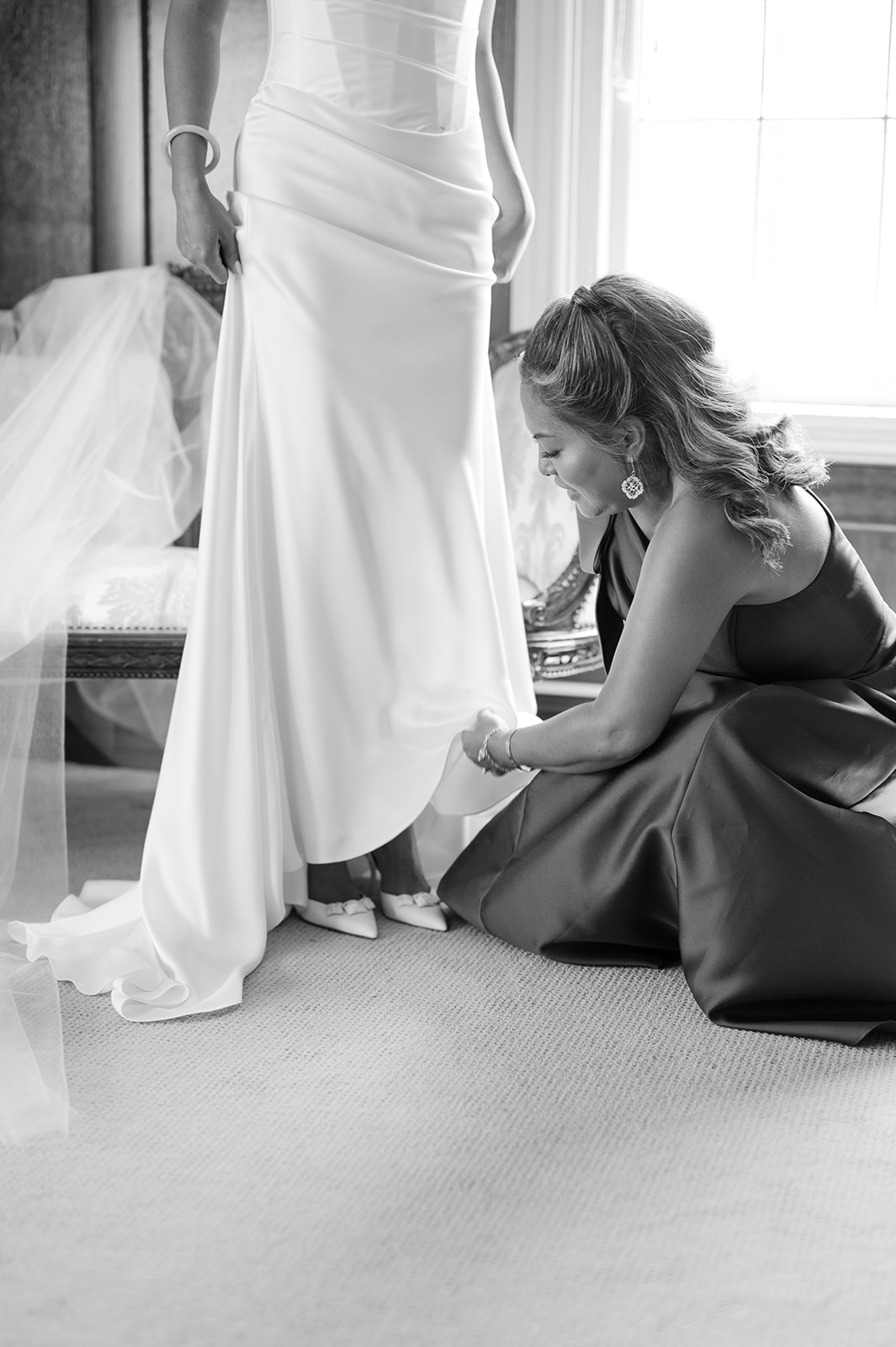 Bride getting ready moment with bridesmaid in bridal suite at Kohl Mansion Burlingame.