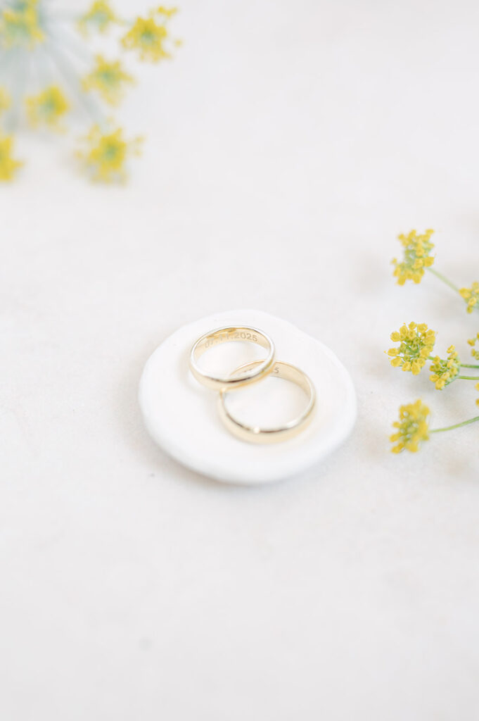 Editorial flat lay of gold wedding bands. 