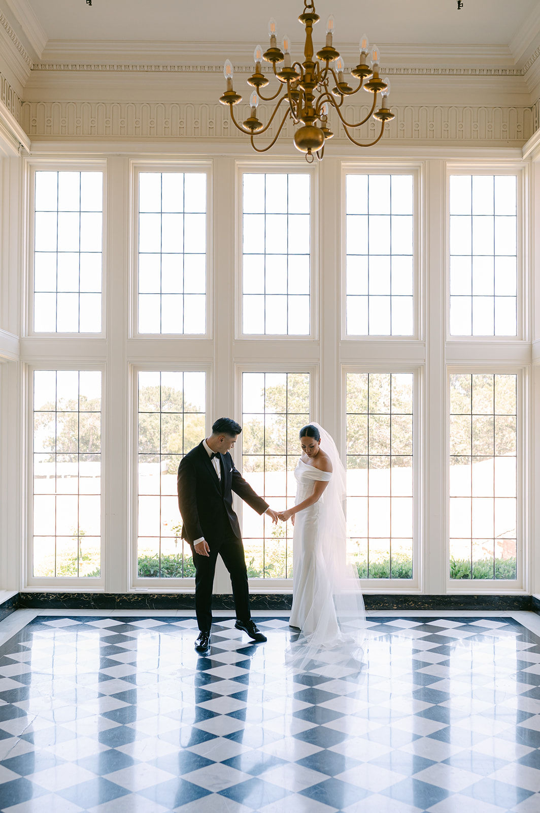 Bride and groom candid moment during first look at Kohl Mansion.