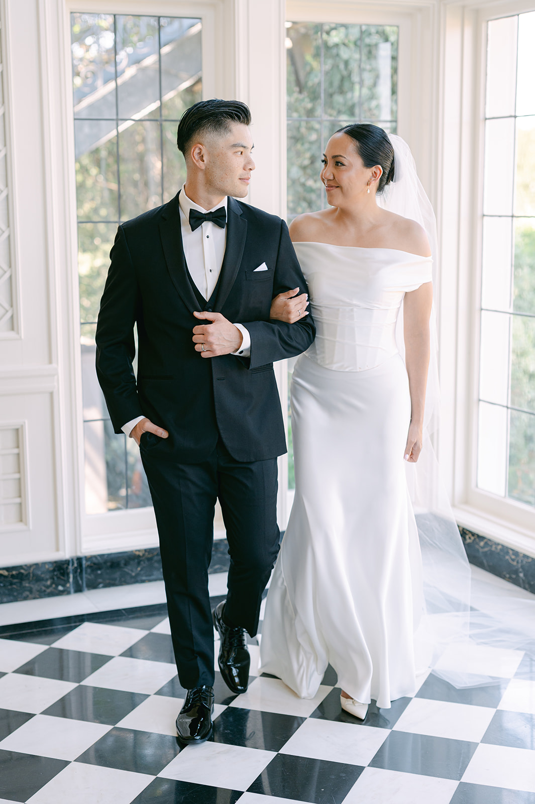 Editorial bride and groom portraits on checkered floors. 