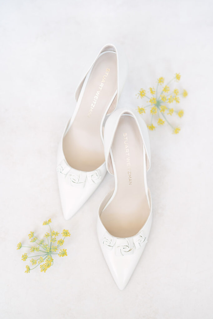 Flat lay of bride’s shoes for understated luxury wedding.