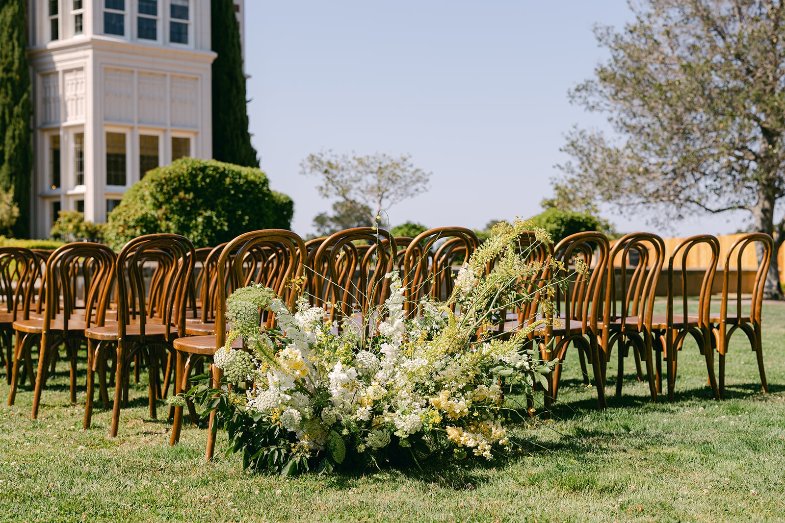 Aisle view of outdoor ceremony at Kohl Mansion wedding. 