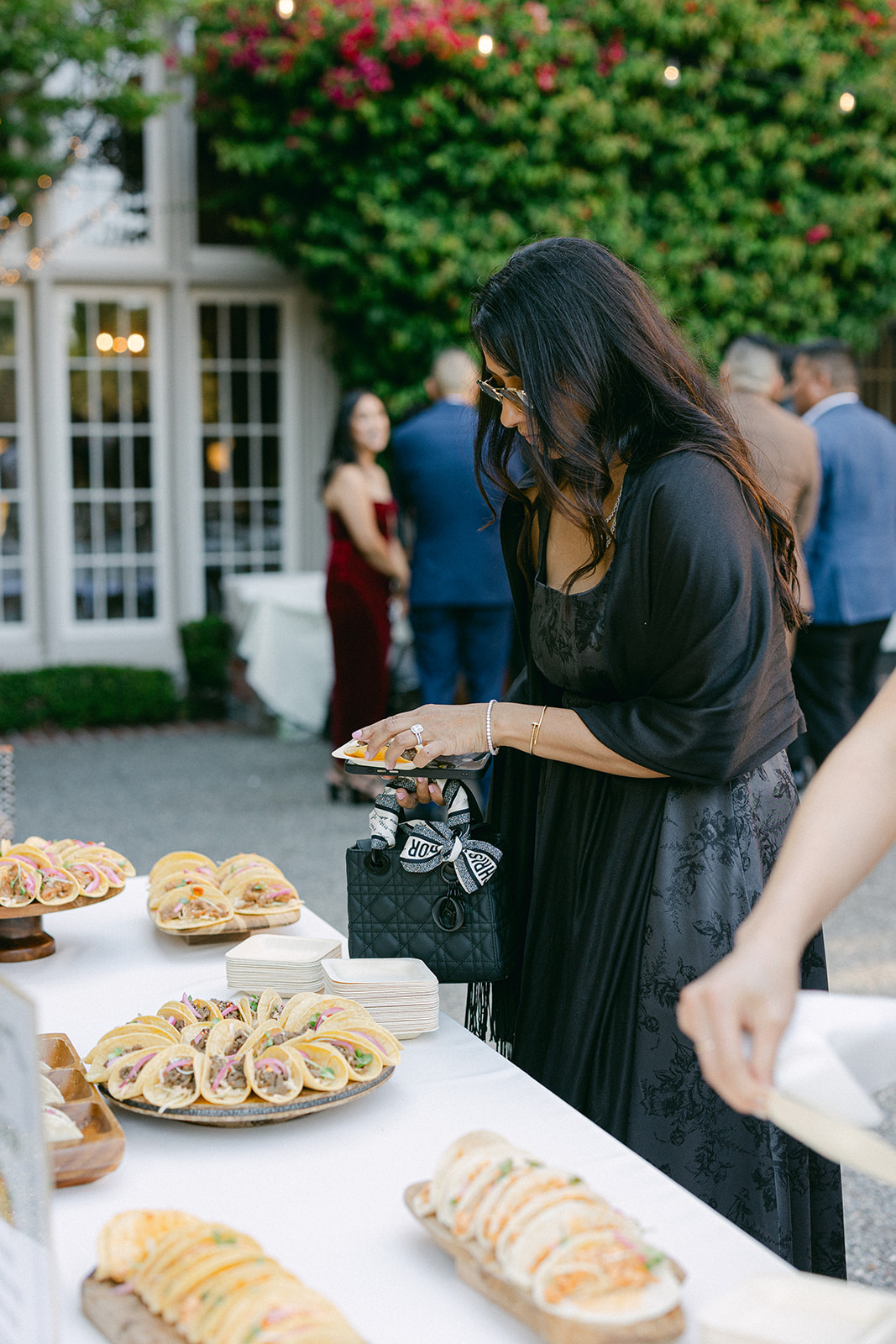 Guests dishing up food at cocktail hour. 