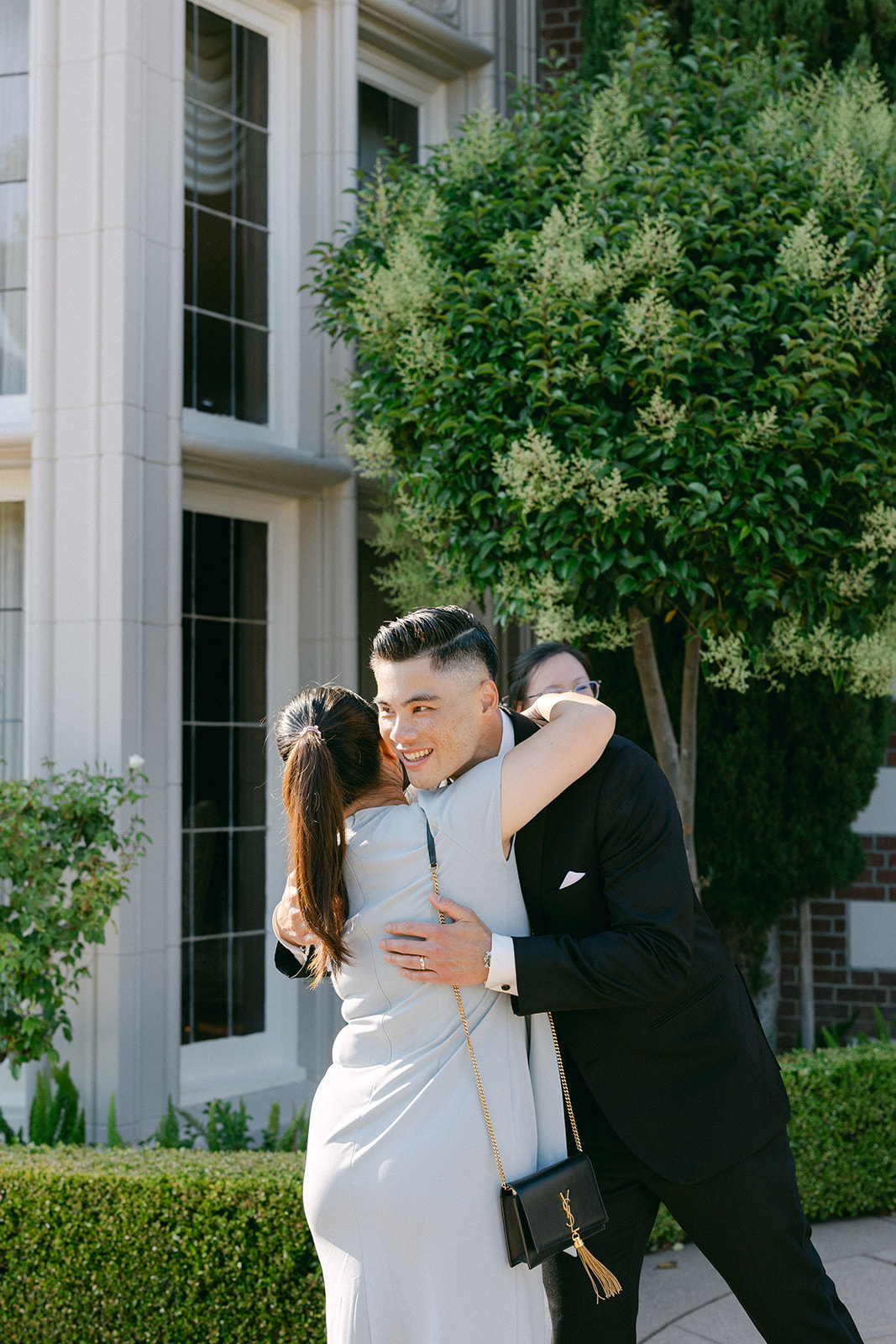 Groom greeting guests during cocktail hour at the mansion.