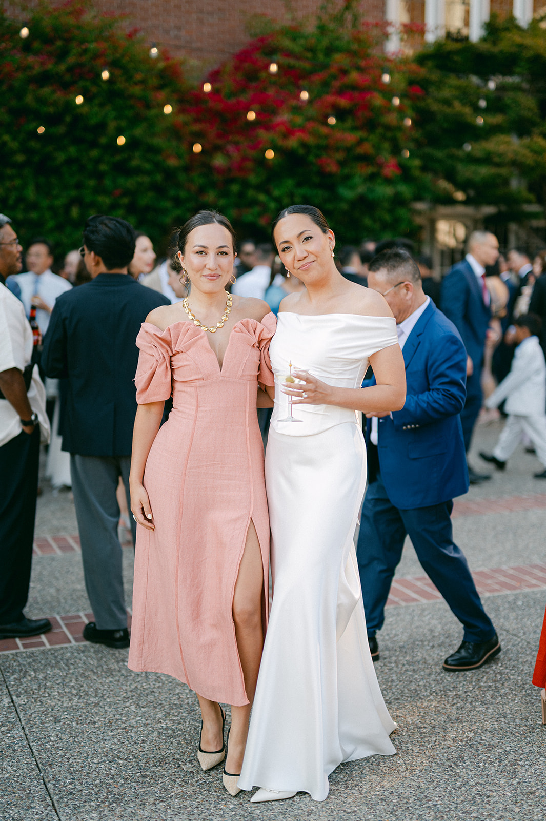 Bride and wedding guest posing for a photo during cocktail hour. 