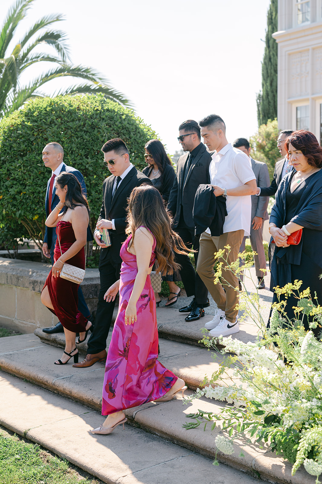Candid photo of guests walking toward outdoor ceremony. 