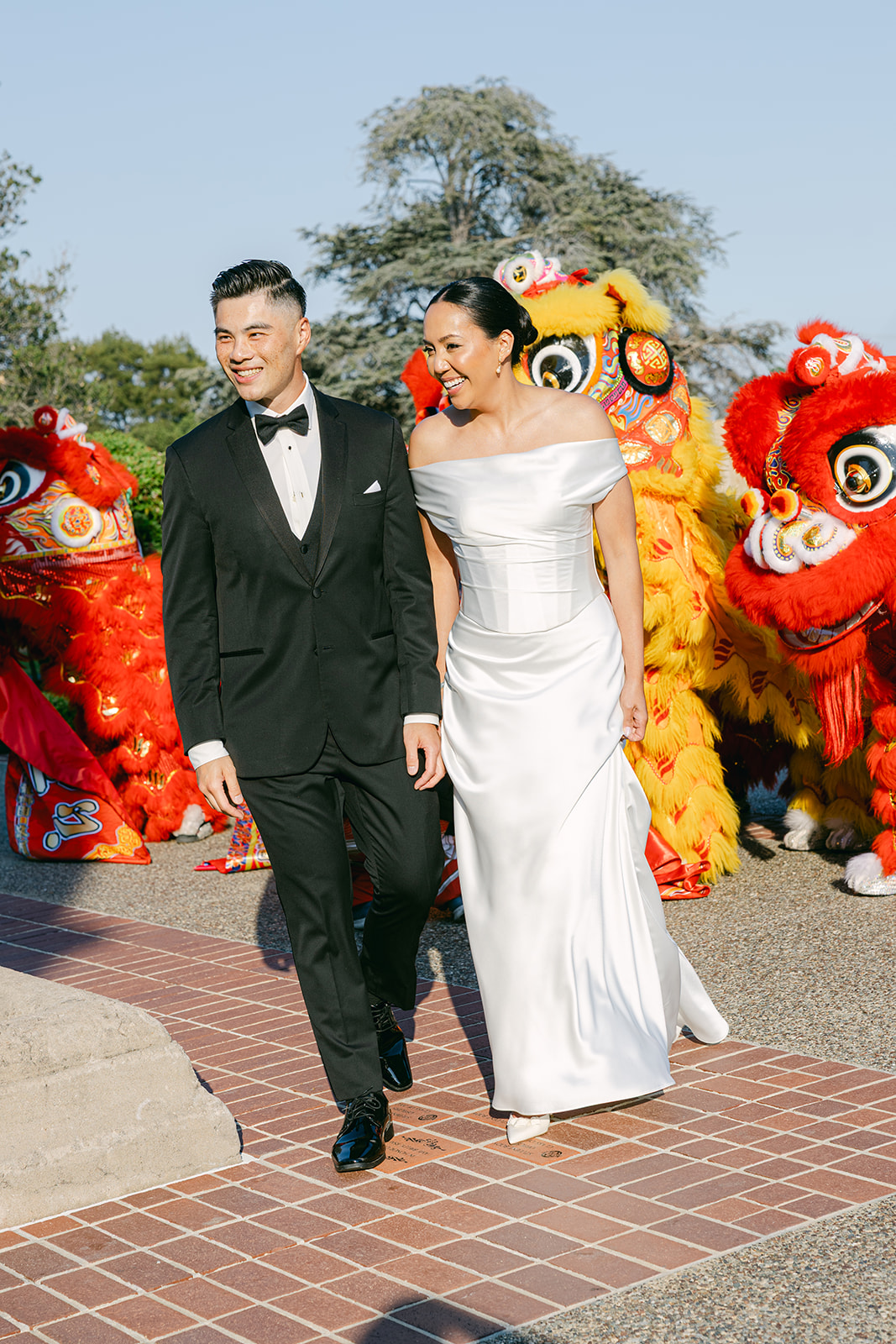 Bride and groom candid photo with Chinese Lion dancers. 
