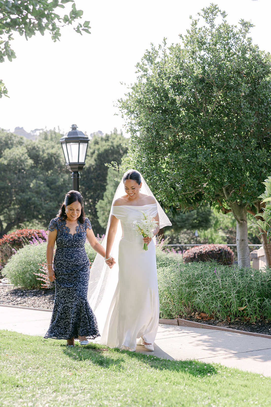 Bride walking down the aisle with her mom at Kohl Mansion wedding