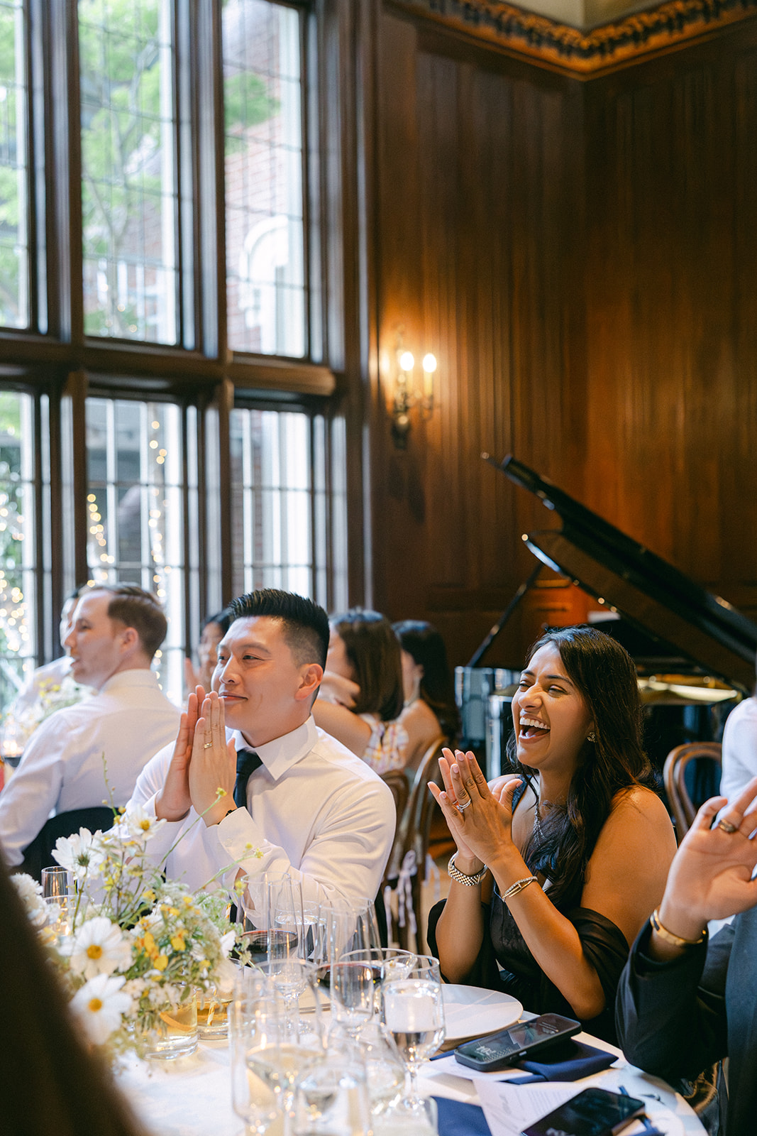 Candid photo of guests during bride and groom reception entrance. 