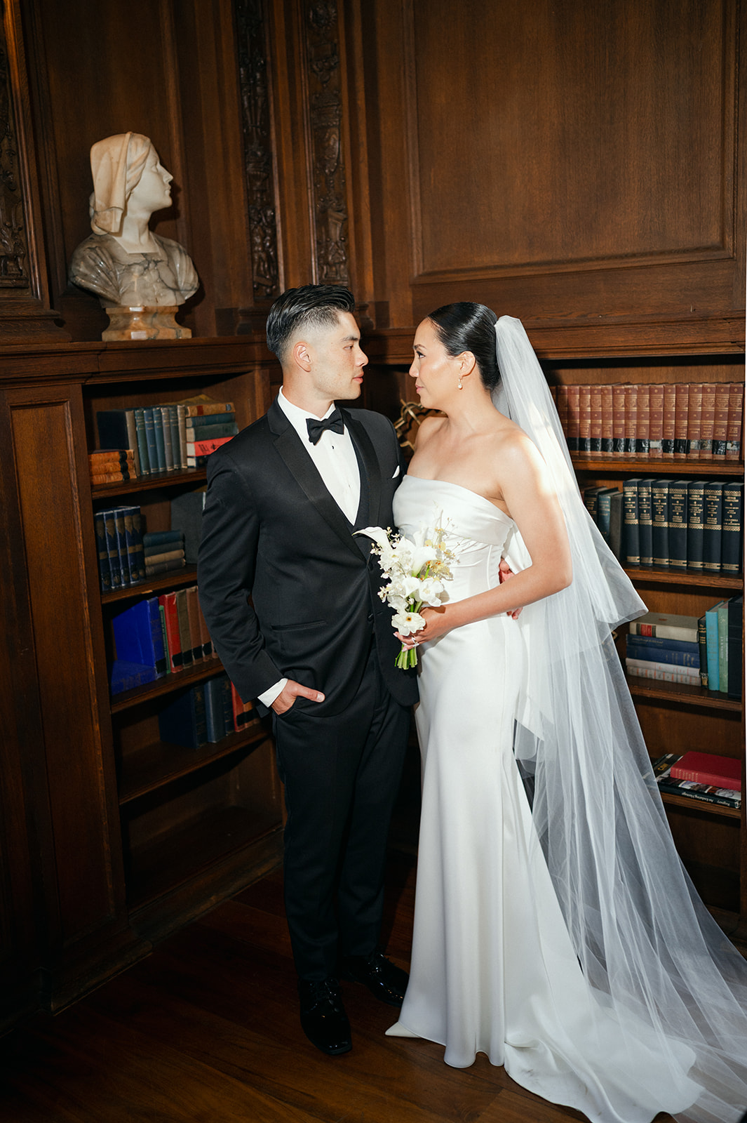 Editorial-style flash couple portraits inside mansion library. 