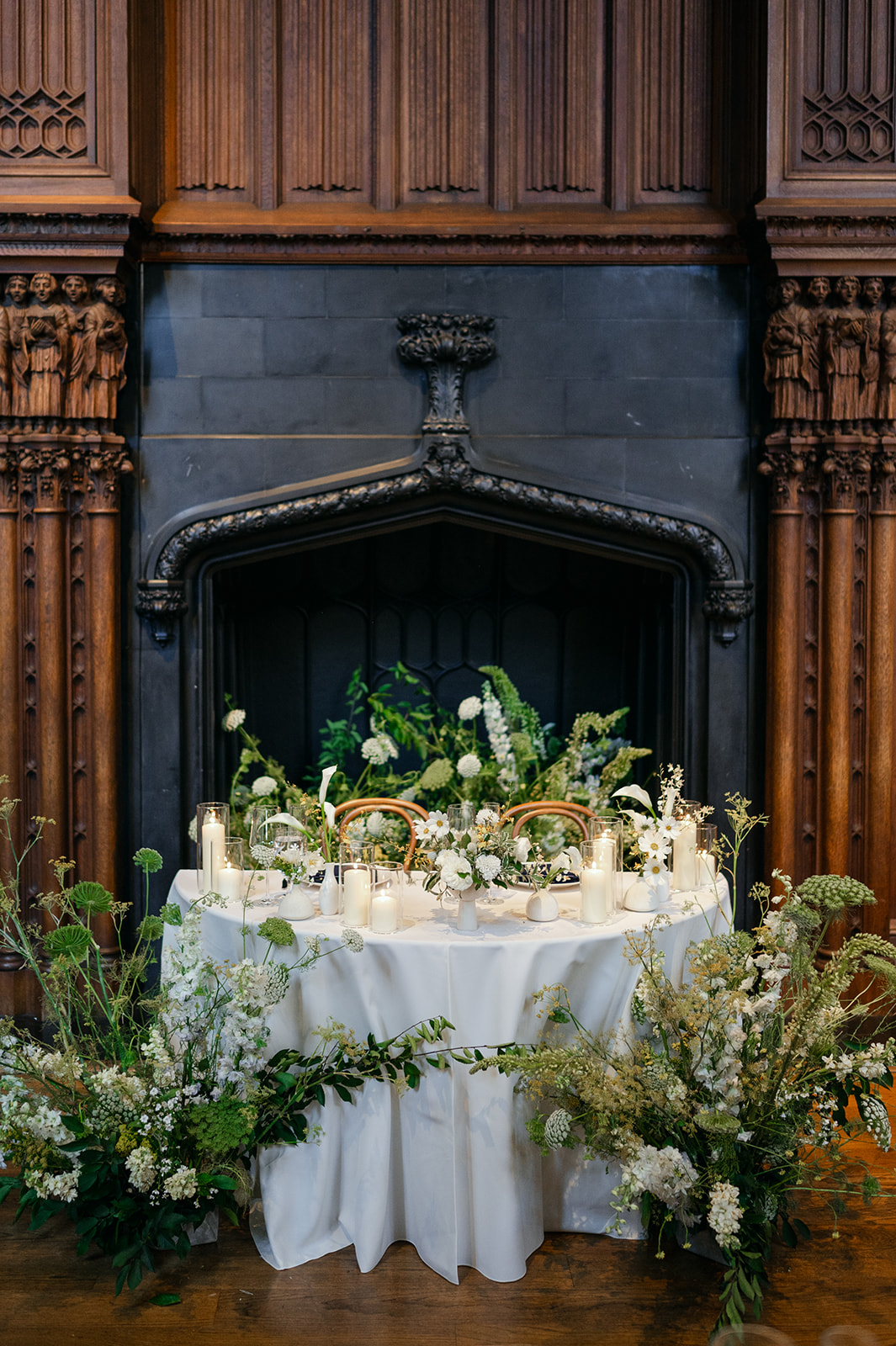 Sweetheart table in front of grand fireplace at Kohl Mansion reception.