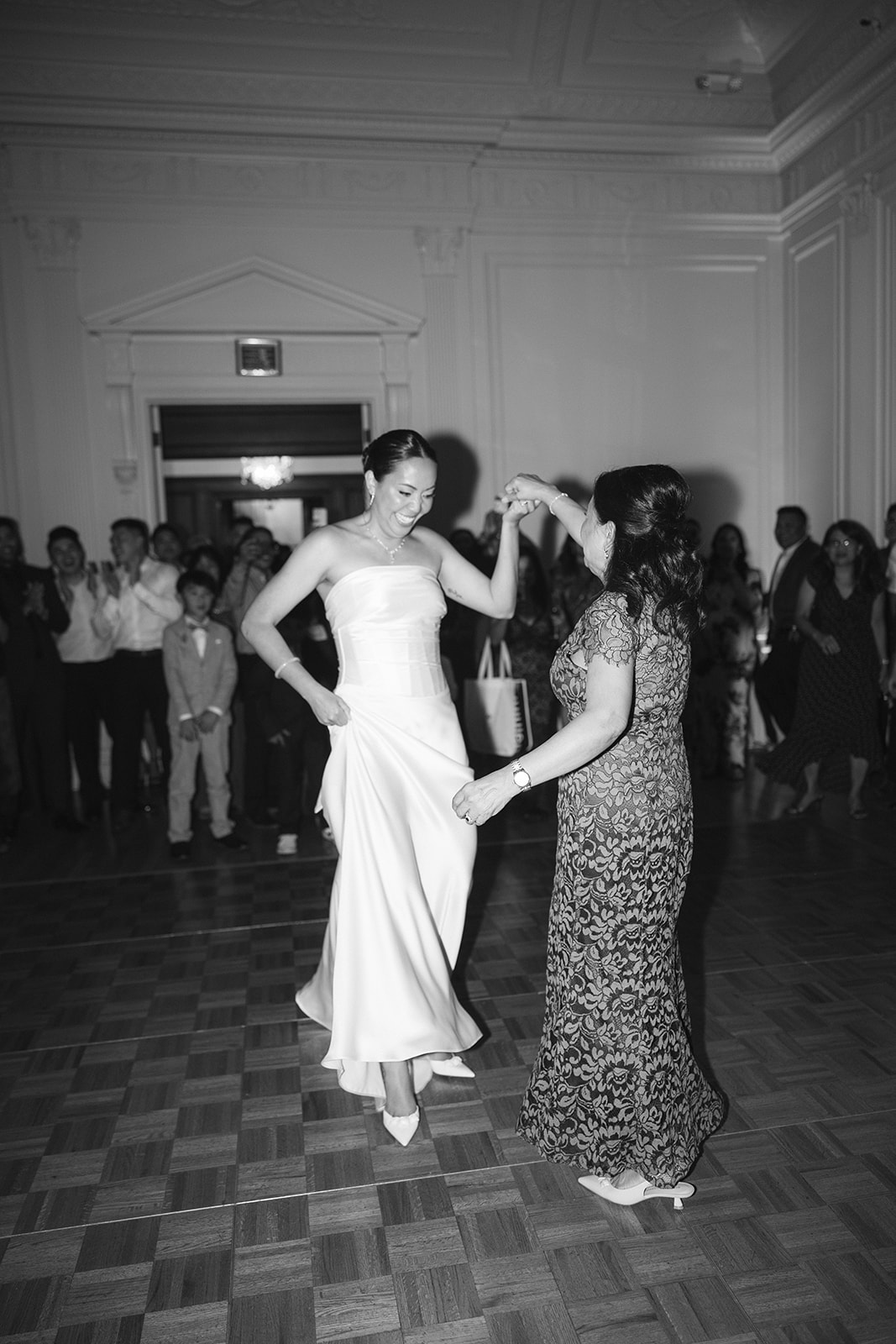 Bride and mom dance candid wedding photography.