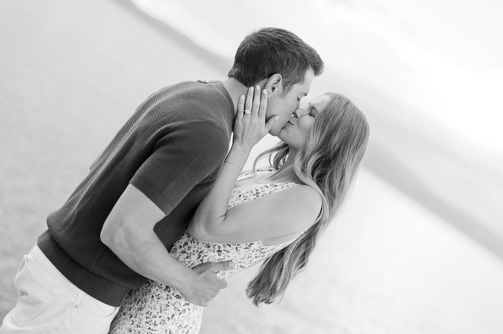 Off-center photo of a couple kissing during their Lake Tahoe engagement session. 