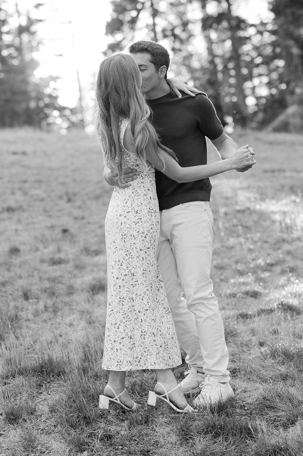 Couple sharing a kiss with pine trees in the background | Lake Tahoe engagement photos. 