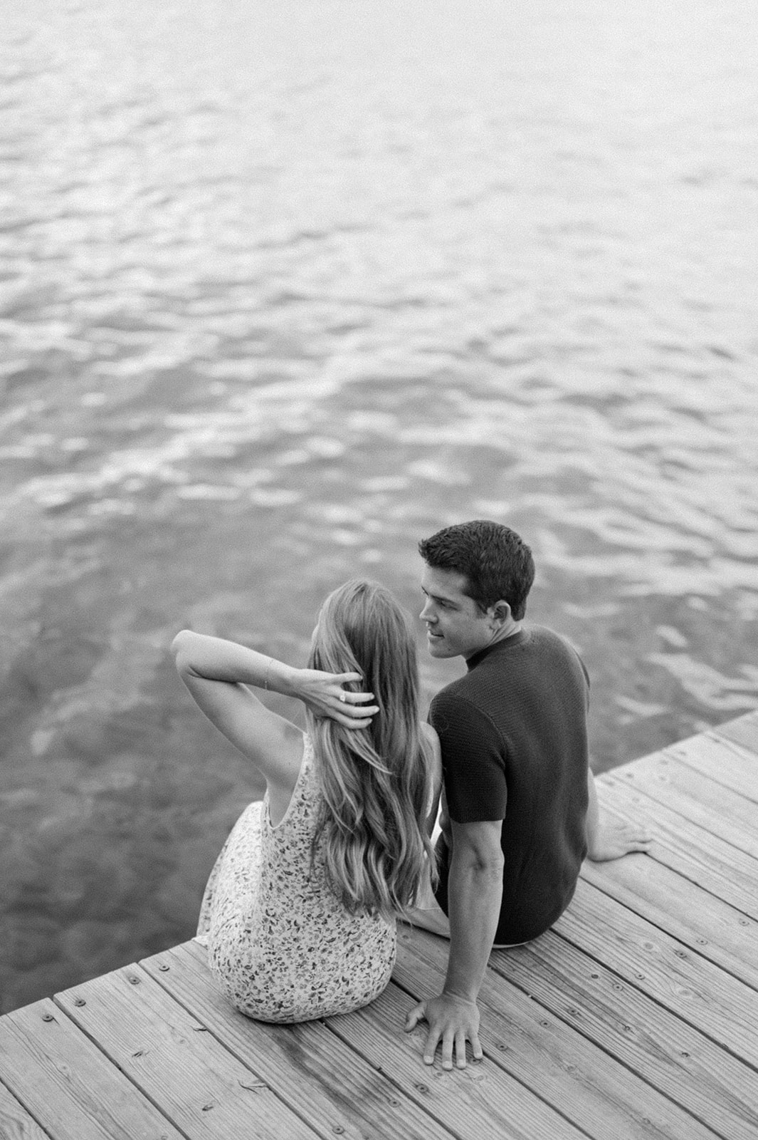 Couple sitting on the edge of the dock | Sugar Pine Point State Park engagement session.