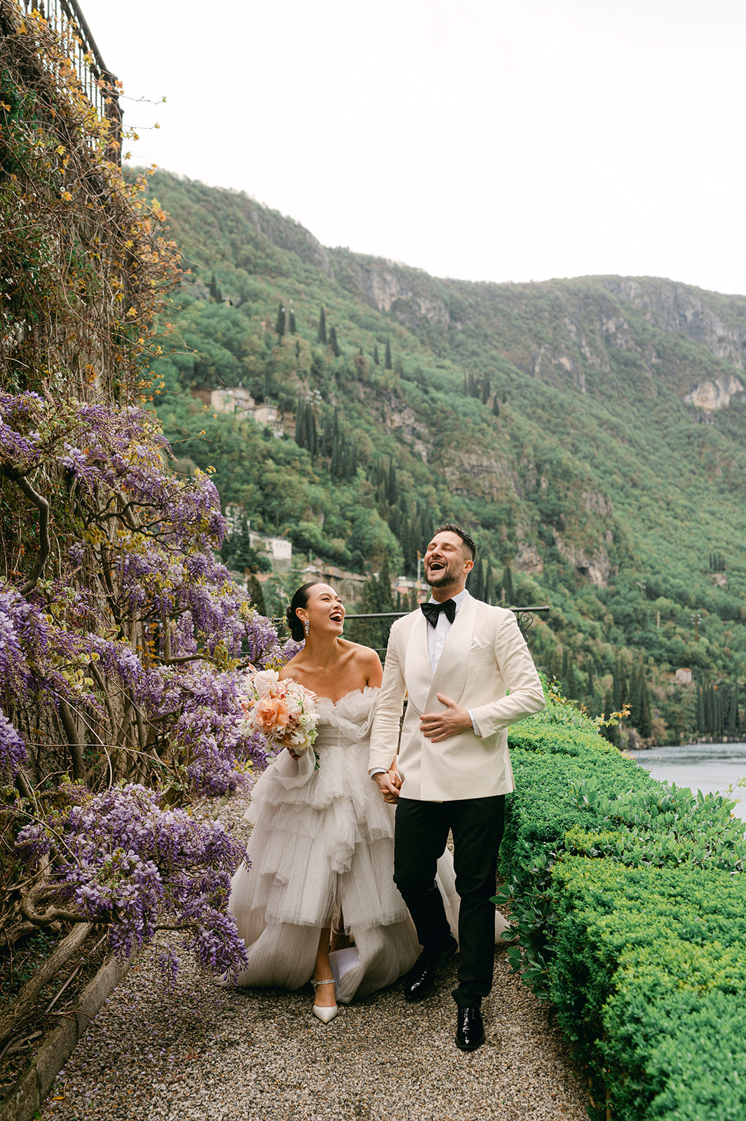 Bride and groom walking and laughing | classic candid wedding photography.