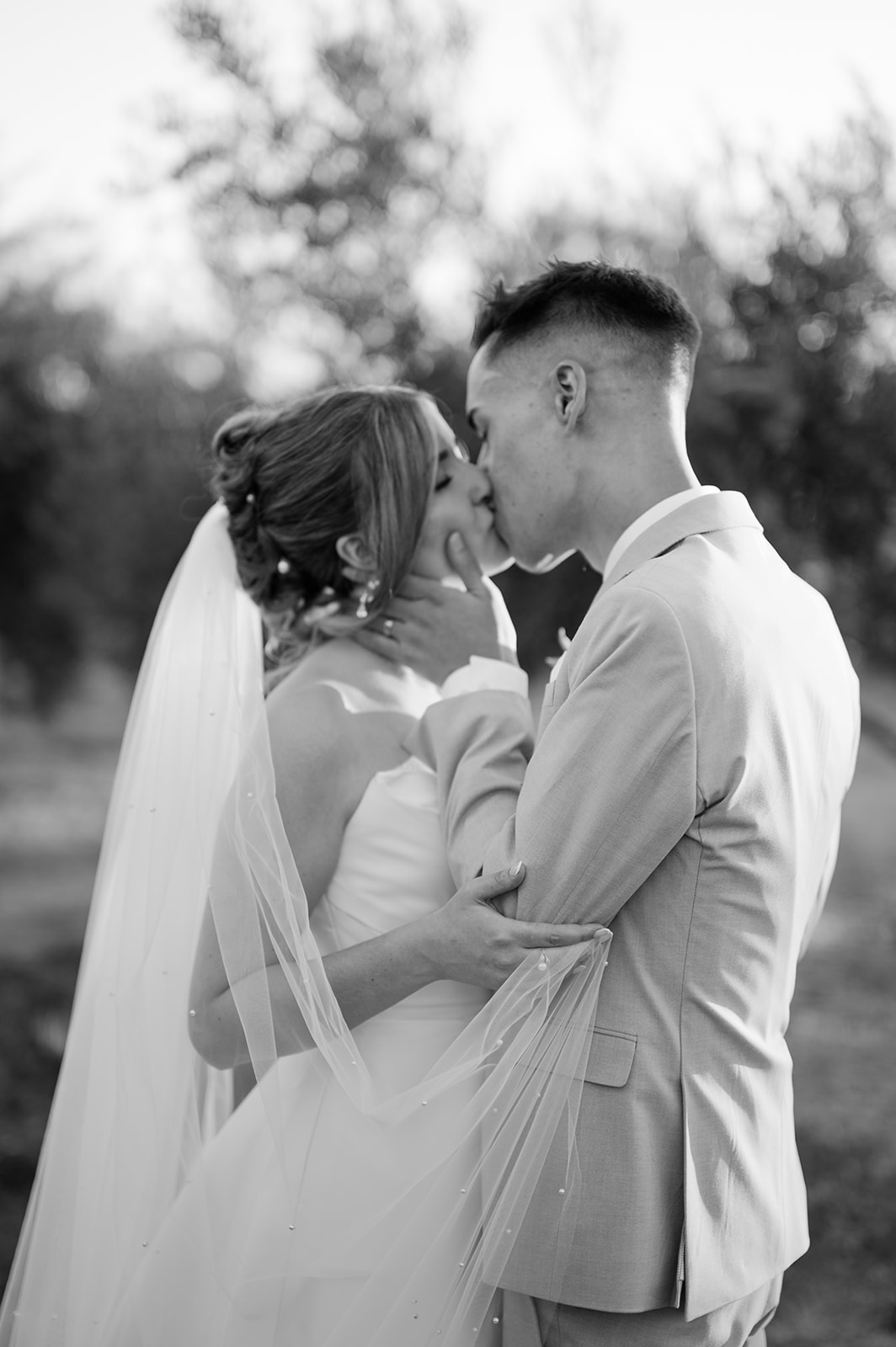 Bride and groom sharing an intimate kiss during portraits.